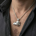 Load image into Gallery viewer, Polished silver Hypnos pendant necklace worn on neck, close lifestyle crop, clear wing detail and classical face relief