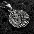 Load image into Gallery viewer, Oxidized sterling silver Viking warrior pendant on textured volcanic rock, Norse helmet profile relief with Greek key border, macro studio shot