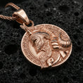 Load image into Gallery viewer, Rose gold plated Norse warrior pendant on matte volcanic stone, intricate warrior helmet relief with decorative frame, sharp macro focus