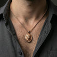 Load image into Gallery viewer, Rose gold plated lion oval pendant worn on neck, detailed lion face relief, clean lifestyle framing with dark shirt contrast