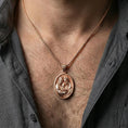 Load image into Gallery viewer, Rose gold plated Holy Family oval medal worn on neck, detailed Mary Joseph and Child relief, clean lifestyle framing with dark shirt contrast