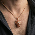 Load image into Gallery viewer, Rose gold plated Chinese dragon head necklace worn on neck, mythical dragon head pendant gift, lifestyle photo