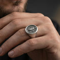 Load image into Gallery viewer, Oxidized sterling silver Virgin Mary signet ring worn on finger, oval Catholic medal ring, lifestyle close-up