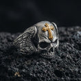 Load image into Gallery viewer, Oxidized sterling silver skull ring with cross on volcanic rock, winged sides, gothic memento mori signet, macro detail