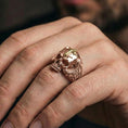 Load image into Gallery viewer, Rose gold plated skull ring with cross worn on finger, memento mori skull signet ring, modern gothic style photo