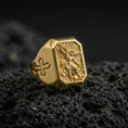 Load image into Gallery viewer, Gold plated Saint Michael signet ring on dark volcanic rock, archangel protector relief, Knights Templar cross side