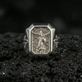 Load image into Gallery viewer, Polished silver St Michael archangel signet ring on porous volcanic stone, angel spear and shield relief, Christian ring