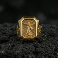 Load image into Gallery viewer, Gold plated St Michael archangel signet ring on dark volcanic rock, winged guardian motif, cross side details