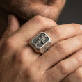 Load image into Gallery viewer, Oxidized sterling silver St Dominic ring worn on finger, saint relief with book, cross shoulder detail close-up