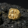 Load image into Gallery viewer, Gold plated Jesus Shepherd signet ring on dark volcanic rock, lamb motif relief, cross shoulder detail close-up