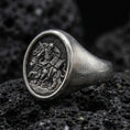 Load image into Gallery viewer, Oxidized 925 sterling silver St Mark signet ring on volcanic rock, winged lion and gospel relief