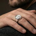 Load image into Gallery viewer, Polished silver St Francis signet ring on hand, Catholic mens ring lifestyle close view