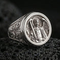 Load image into Gallery viewer, Polished silver St Michael signet ring on porous volcanic stone, detailed archangel portrait, ornate scrollwork band