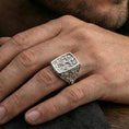 Load image into Gallery viewer, Polished silver INRI cross ring worn on finger, rectangular crucifixion signet face, ornate engraved band