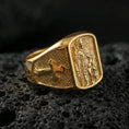 Load image into Gallery viewer, Gold plated Saint Roch signet ring on dark volcanic rock, patron saint of protection relief, engraved cross shoulders and vintage texture