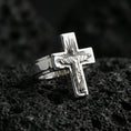 Load image into Gallery viewer, Polished silver Jesus crucifix ring on porous volcanic stone, detailed Christ figure engraving, bold cross silhouette ring