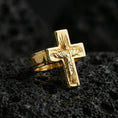Load image into Gallery viewer, Gold plated Jesus crucifix ring on dark volcanic rock, Christian cross statement ring, engraved Christ figure and sunburst halo