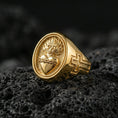 Load image into Gallery viewer, Gold plated Sacred Heart signet ring on dark volcanic rock, flaming heart and cross motif, Catholic devotional statement ring