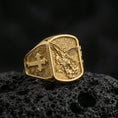 Load image into Gallery viewer, Gold plated Archangel Michael ring on dark volcanic rock, Saint Michael defeating evil relief with bold cross band
