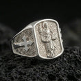 Load image into Gallery viewer, Polished silver Saint Dominic ring on porous volcanic stone, Dominican saint figure engraving and cross band