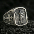 Load image into Gallery viewer, Oxidized 925 sterling silver Saint Michael ring on volcanic rock, archangel defeating devil relief with cross band