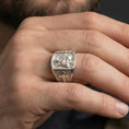 Load image into Gallery viewer, Polished silver Saint Anthony signet ring worn on finger, detailed saint and Child Jesus engraving with cross motif side