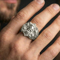 Load image into Gallery viewer, Polished silver skull signet ring worn on finger, natural wear shot highlighting the detailed knotwork and strong statement look