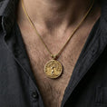 Load image into Gallery viewer, Gold plated Yggdrasil tree of life pendant worn on neck, Norse inspired round medallion with leaf bail on braided chain