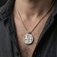 Load image into Gallery viewer, Polished silver ankh medallion worn on neck, Eye symbol pendant necklace with engraved Egyptian pattern and clean circular silhouette