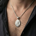 Load image into Gallery viewer, Polished silver Medusa coin necklace worn on neck, Greek key framed medallion with classic Greek goddess profile detailing