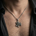 Load image into Gallery viewer, Oxidized 925 sterling silver trinacria pendant worn on neck, sicilian triskelion medusa necklace bold statement look