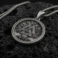 Load image into Gallery viewer, Oxidized 925 sterling silver valknut pendant on volcanic rock, Viking Norse symbol necklace with tree texture background