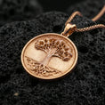 Load image into Gallery viewer, Rose gold plated Tree of Life necklace on dark volcanic stone, circular coin pendant with raised branches and roots