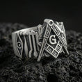 Load image into Gallery viewer, Oxidized sterling silver Masonic square and compass ring on black volcanic rock, macro close-up showing deep patina and engraved details