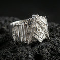 Load image into Gallery viewer, Polished silver Freemason square and compass signet ring on porous volcanic stone, close-up highlighting crisp edges and smooth shine
