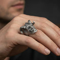 Load image into Gallery viewer, Oxidized horned skull ring worn on a finger, lifestyle close-up showing the oversized sculpted skull face and dark patina depth