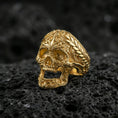 Load image into Gallery viewer, Gold plated baroque skull ring with intricate filigree patterns on volcanic rock, premium macro photo emphasizing warm tone, high-relief carving and gothic luxury style
