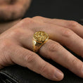 Load image into Gallery viewer, Gold plated spiral sun signet ring worn on a finger, lifestyle image focusing on the raised swirl design and bold profile