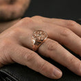 Load image into Gallery viewer, Rose gold plated spiral signet ring on the finger, close-up lifestyle photo showcasing the ornate spiral face and patterned band