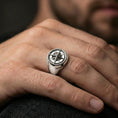 Load image into Gallery viewer, Polished silver compass ring on the finger, wearable shot focusing on the 3D wind rose face and clean tapered band