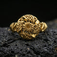 Load image into Gallery viewer, Gold plated Celtic windflower ring with intricate openwork flower design and braided Celtic accents, product-only macro image on black volcanic rock
