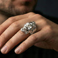 Load image into Gallery viewer, Polished silver skull ring with beard design on the finger, wearable close-up emphasizing depth and bold statement style