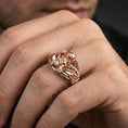 Load image into Gallery viewer, Rose gold plated winged skull biker ring worn on a finger, close-up lifestyle image showing the sculpted skull and rugged details