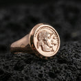 Load image into Gallery viewer, Rose gold plated Greek coin ring showing a vintage portrait coin face and rounded signet shank, close-up on volcanic rock