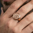 Load image into Gallery viewer, Rose gold plated Greek coin ring on the finger, close-up lifestyle image showing the antique coin portrait and smooth band