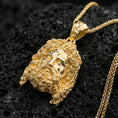 Load image into Gallery viewer, Gold plated deity head pendant on volcanic rock, premium studio lighting, ornate bail and braided chain detail