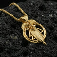 Load image into Gallery viewer, Gold plated Odin spear raven necklace pendant on volcanic rock, premium studio scene, Viking-inspired amulet centerpiece