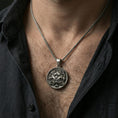 Load image into Gallery viewer, Oxidized guardian lion medallion necklace worn on neck, lifestyle close-up, pendant centered with braided chain