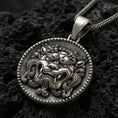 Load image into Gallery viewer, Oxidized sterling silver guardian lion medallion pendant on volcanic rock, beaded rim and bold relief detail, macro shot