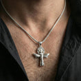 Load image into Gallery viewer, Polished silver winged ankh cross necklace worn on neck, clean lifestyle framing, reflective finish and sharp etching